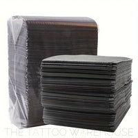 Black dental bib tray liners, close-up