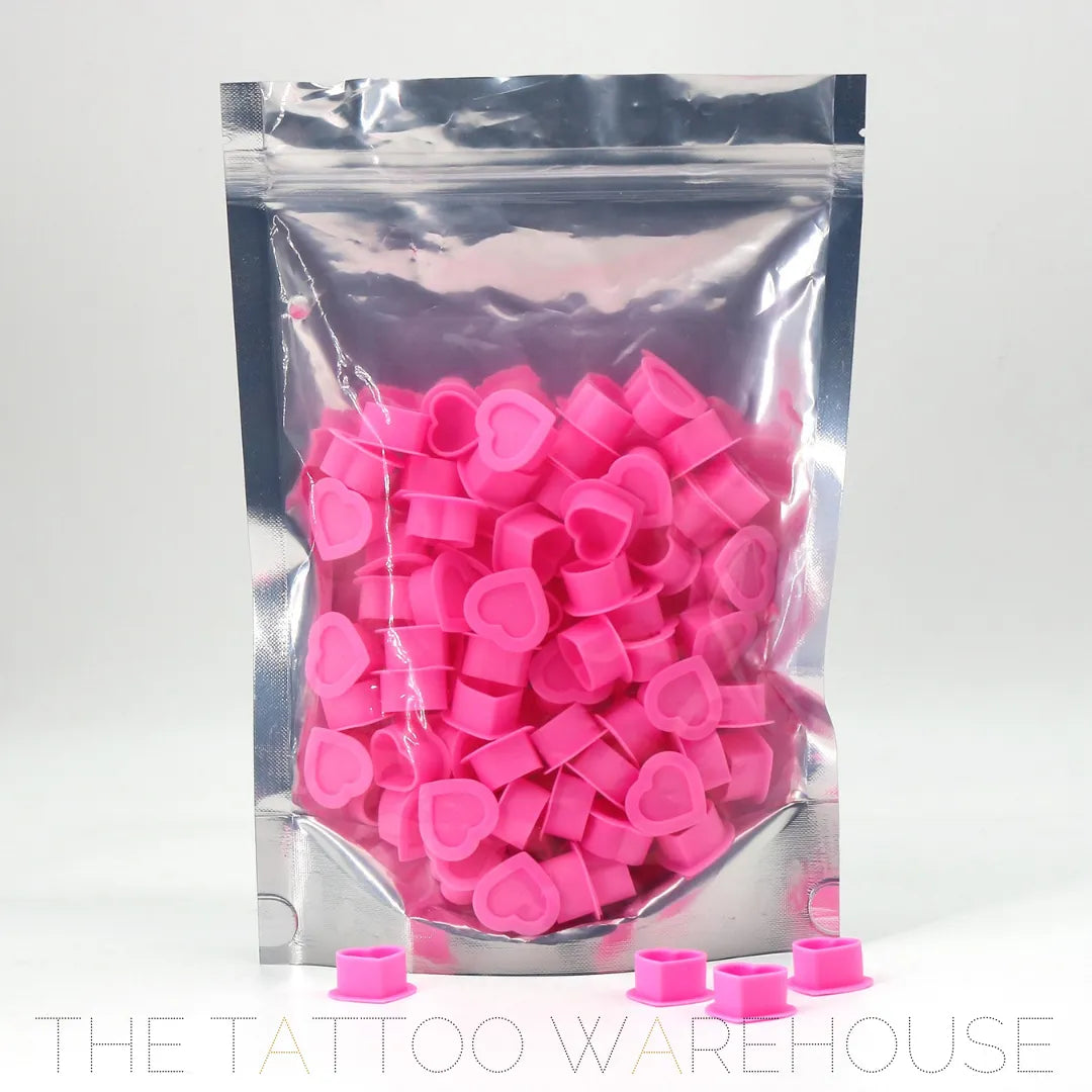 Silicone pink heart-shaped ink cups, close-up