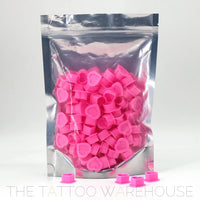 Silicone pink heart-shaped ink cups, close-up