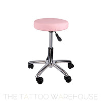 Pink rolling stool for tattoo studio